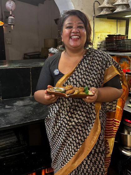 This is me, beaming with joy at my pop-up in Goa. Holding a plate of my food and seeing happy guests is what it's all about. I cherish these collaborations and can't wait for more.