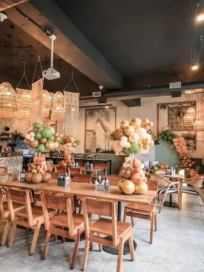 A wide view of the cafe, showing how our themed decor, including table centerpieces, transformed the space.