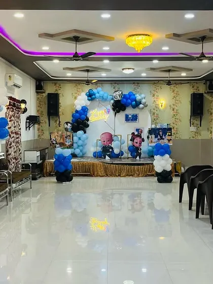 A wide view of the Boss Baby themed party hall decoration. This shows how I can transform an entire space, including the stage, entrance, and photo displays, to fit your chosen theme.