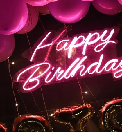 A close-up of a "Happy Birthday" neon sign, a popular add-on that brings a modern and fun vibe to any party.