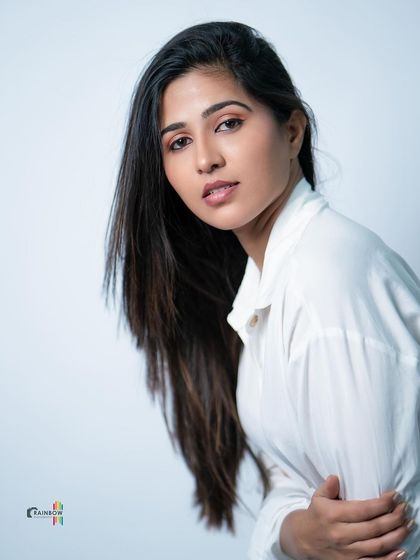 A tilted, artistic shot of a model in a white shirt, creating a modern and edgy feel.