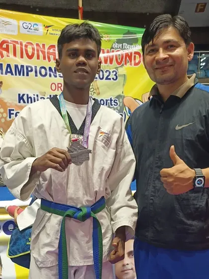This student proudly displays his silver medal after the championship.