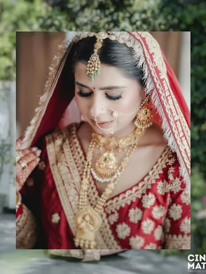 A gentle, downward glance from the bride, highlighting her elaborate necklace and the delicate embroidery on her dupatta.