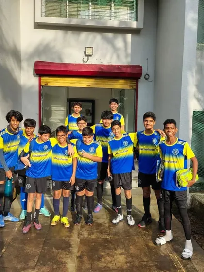 The residential academy team stands together outside the campus building. This photo shows the camaraderie and team spirit that is built both on and off the football field.