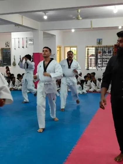 A senior student leads the class in practice.