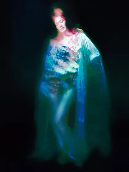 A dynamic shot using long exposure and light trails to create a ghostly, underwater feeling. This image captures the fluid movement and emotional depth of the 'Ophelia' narrative.