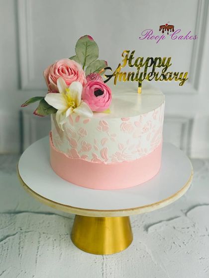 A sweet celebration of love, wrapped in blush and blooms. This pink and white stenciled cake is perfect for an anniversary.