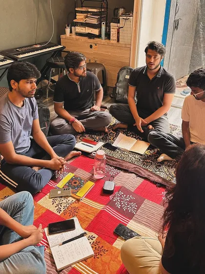 Students engage in a group discussion during a Hindustani vocal class. Our sessions are interactive, encouraging questions and a deeper understanding of the music.