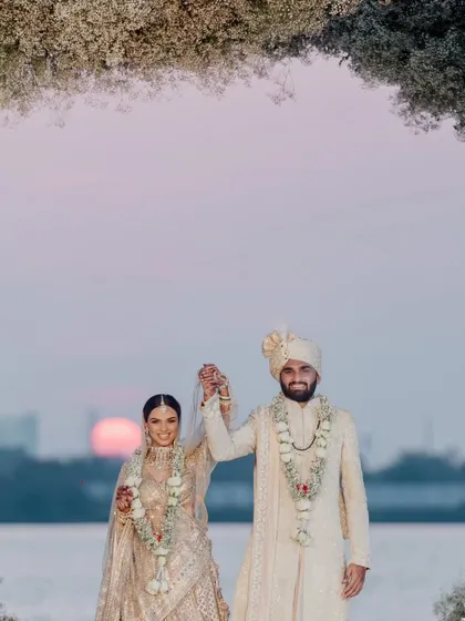 An eternal love, sealed with vows under the sunset sky in Kochi. Even the sun made a special appearance, casting a radiant glow upon this ethereal white floral mandap, adding the perfect touch to a magical sunset wedding.