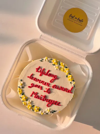 Celebrate a personal achievement with a custom award cake. This bento recognizes a "lifelong learner" with a fun message and a delicate floral border.