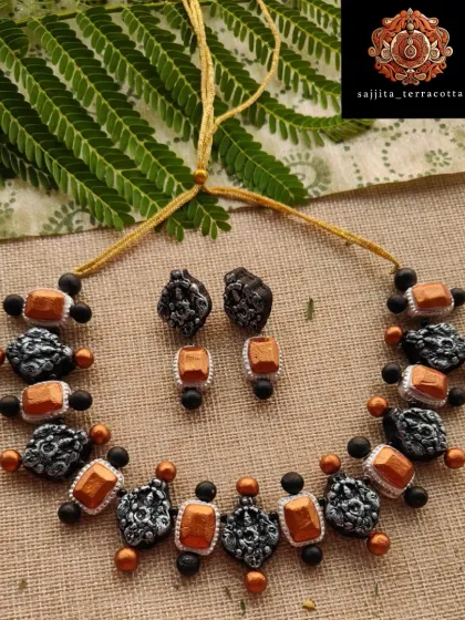 A fusion of temple and stone jewelry styles, this necklace features Lakshmi charms alongside copper-colored elements. This unique combination is great for customers looking for something traditional yet different.