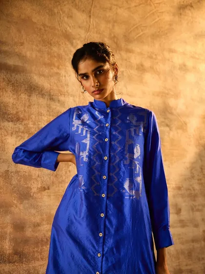 A vibrant blue tunic with silver foil print, styled for a festive lookbook. My focus was on creating a clean, striking image that highlights the rich color and traditional motifs of the garment.