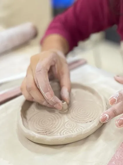 Adding small, decorative elements to a hand-built dish. This is where you can really let your personality shine through in your work.