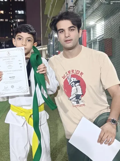 This student is all smiles after passing his belt grading exam. Congratulations on leveling up.