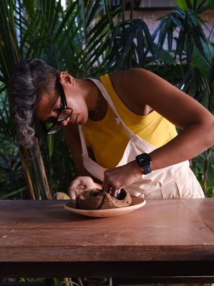 Me, working on a hand built piece in our lush, green studio space, a perfect environment for creativity to flourish.