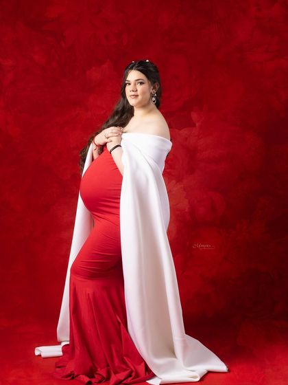 When beauty meets anticipation, this stunning mama-to-be glows. The bold red and white combination creates a regal and powerful statement.