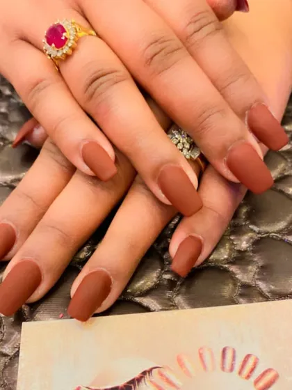 A sophisticated and modern choice, these long coffin nails feature a solid, deep brown color with a smooth matte finish.