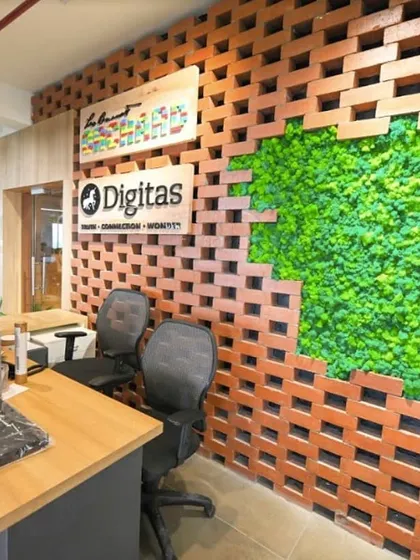 A creative moss wall feature at the Digitas office reception. Here, we integrated a patch of lush, preserved moss into an exposed brick wall, creating a striking contrast between natural and industrial textures.