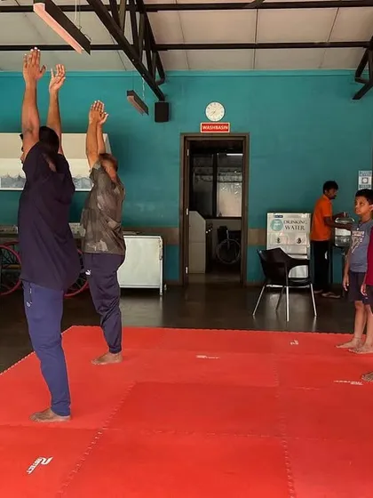 We teach students of all ages the benefits of yoga. Here, both young and adult members of our SSKKA family practice balancing postures, demonstrating that the journey of physical and mental wellness has no age limit.