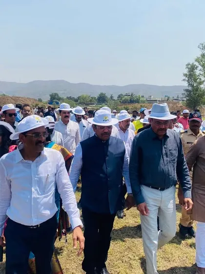 Walking the grounds with the official delegation, discussing the potential of the new facility.