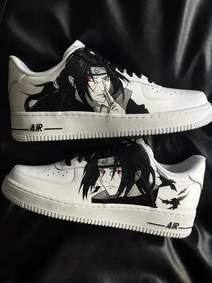 A pair of white Nike Air Force 1s with a striking custom design of Itachi Uchiha from Naruto.