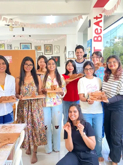 A happy group of participants with their finished clay pieces. Everyone leaves with a unique, handmade item and a sense of accomplishment.