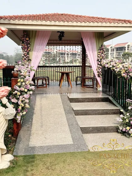 A charming gazebo at the venue, decorated with pastel drapes and floral arrangements, creating another picturesque spot.