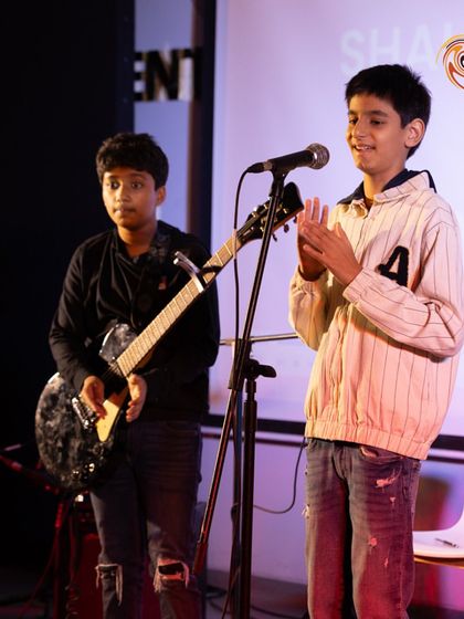 A duo on electric guitar and vocals, capturing the collaborative spirit we foster in our band programs.