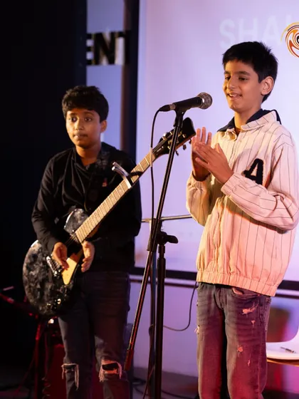 A duo on electric guitar and vocals, capturing the collaborative spirit we foster in our band programs.
