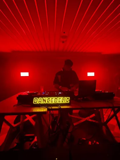 Standing at the helm in a room washed in red light. This is where I command the dancefloor, track by track.