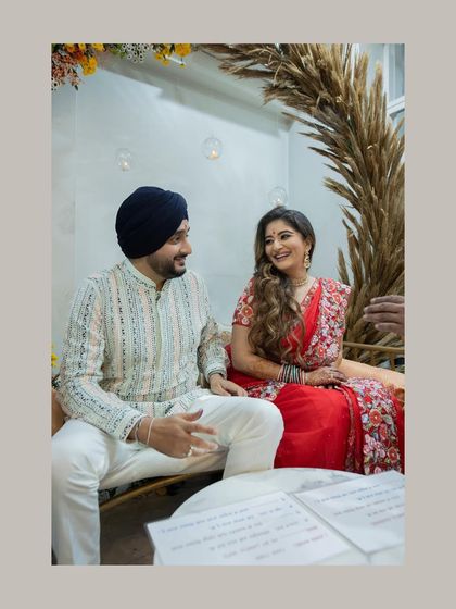 A relaxed portrait of the couple during their at-home registered marriage ceremony. Their happy smiles show the joy of getting married in a comfortable, personal setting.