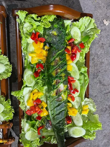A beautifully presented grilled fish, marinated in a green herb paste and cooked to flaky perfection. A healthy and delicious option for any menu.
