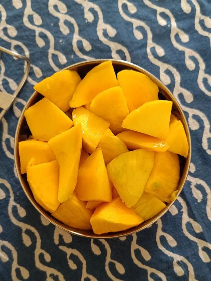 A bowl of freshly cut ripe mangoes, a sweet and healthy treat I provided as part of a sunny summer menu.