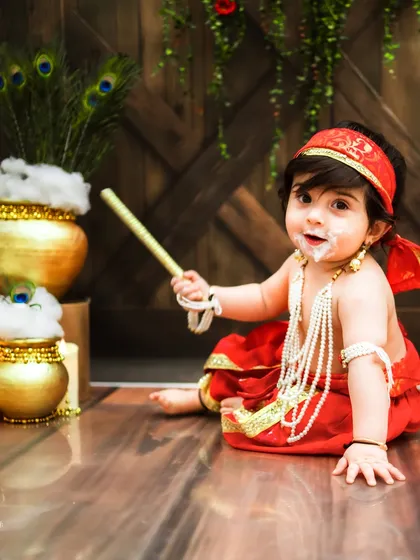 A little messy, a lot of cute. This little Krishna is having the best time during his Janmashtami shoot.