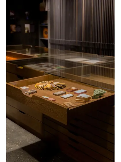 We designed custom pull-out trays with glass tops to display smaller samples, making it easy for clients to see and select finishes.