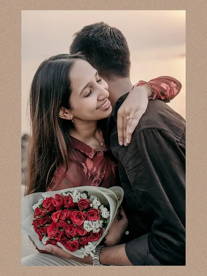 A tender moment captured at sunset by the Mumbai sea. The bouquet of red roses adds a classic romantic touch to this beautiful and emotional pre-wedding portrait.