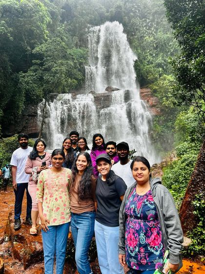 Our group posing in front of a stunning multi-tiered waterfall during our Explore Chikmagalur trip.
