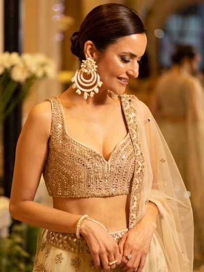 A close-up of our client's makeup for an evening event. The look features a soft smokey eye, glowing skin, and a polished low bun, paired with stunning oversized earrings.