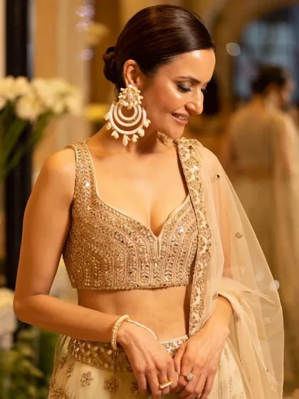 A close-up of our client's makeup for an evening event. The look features a soft smokey eye, glowing skin, and a polished low bun, paired with stunning oversized earrings.