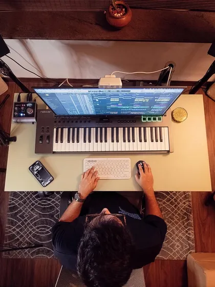 An overhead view of my workspace. My home studio is equipped for professional music production, with everything needed for keyboard arrangements, vocal recording, and mixing a track from start to finish.