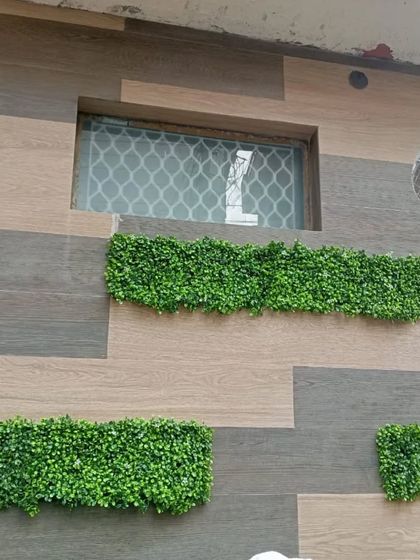 The completed geometric installation, providing a unique green accent below a window.
