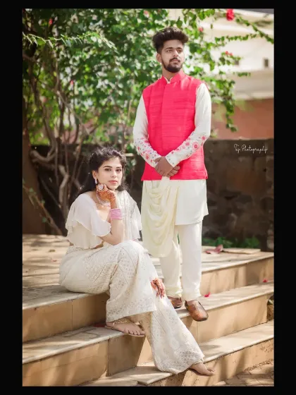 A stylishly posed shot on a set of outdoor stairs. The couple's elegant attire and confident poses create a fashionable and modern portrait with a touch of traditional grace.