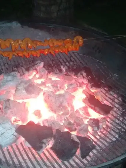 The heart of our barbecue service. Skewers of marinated prawns grilling over glowing charcoal, ready to be served hot and smoky at a private party.