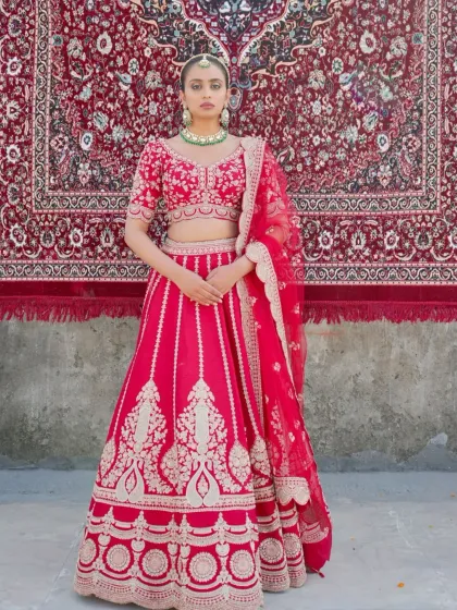 A full view of a bright red lehenga with elegant silver-gold embroidery. The design is perfect for the bride who wants a classic look that is still light and comfortable to wear.
