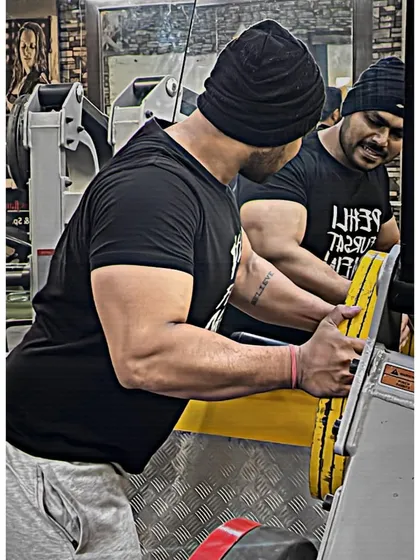 Loading plates on a machine. The sound of iron is the sound of progress.