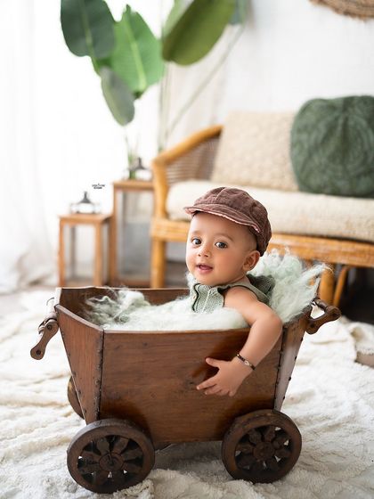 This little adventurer is ready to explore in his wooden wagon.