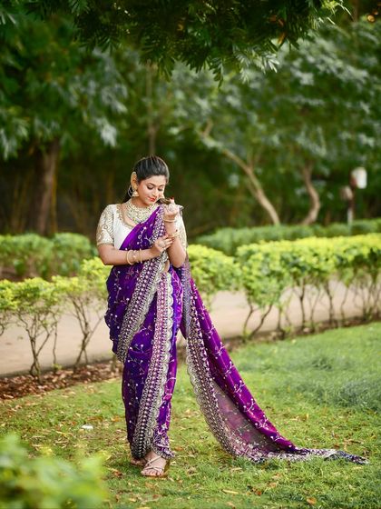 The full view of this stunning purple Nauvari, showcasing its elegant drape and detailed silver embroidery, ideal for a Diwali party.