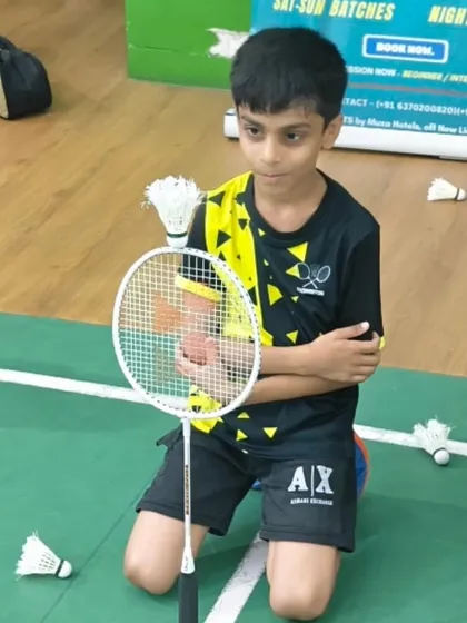 This young athlete takes a quick break between drills. The intensity of the training is balanced with moments for rest and recovery.