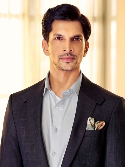 We create classic Italian silhouettes from the finest fabrics. This dark plaid blazer, paired with a light blue shirt, is perfect for a look that is both professional and stylish.