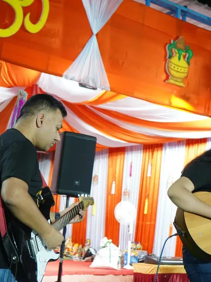 Here I am performing on electric guitar alongside one of our students on acoustic guitar during the Ganesh Chaturthi celebration. Mentors and students playing together is a core part of our community philosophy.